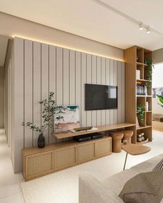 a living room filled with furniture and a flat screen tv on top of a wooden shelf