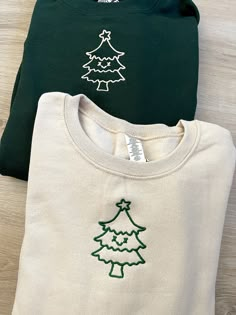 ✰COMES WITH TWO! Photo features: Forest Green X Tan Thread // Tan X Green Thread ✰Embroidered Matching Sweatshirts✰UNISEX✰Hand drawn and designed✰Super soft and comfy! *Sizes 2XL-3XL may be subject to longer processing times since we don't carry a large amount of inventory in those sizes, so we would have to put in a special order from our supplier! Thank you for understanding. Christmas Prints For Shirts, White Embroidered Sweatshirt For Winter, Winter Sweatshirt Ideas, Winter Green Embroidered Hoodie, Green Embroidered Crew Neck Hoodie, Cozy White Embroidered Sweatshirt, Hooded Cotton Sweatshirt With Machine Embroidery, Hooded Tops With Machine Embroidery For Winter, Green Cotton Hoodie With Embroidered Graphics