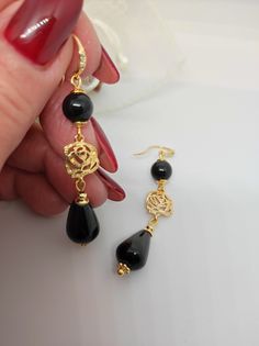 Beautiful handmade earrings with black agate beads and 18K gold plated metal components. For this creation I was inspired by the classic 50s style. I used the contrast of gold and black colors which makes the earrings very elegant. The earrings are long, very elegant and romantic thanks to the floral elements as connectors. Suitable for an elegant evening dress for an important party. They match with some long agate necklaces that I offer in my shop. All jewels are delivered in a decorated box, ready to be given as a gift to your loved one. How to take care of your jewellery: put on your beauty products (cosmetics, perfumes, ...) before wearing your precious jewel. Clean your jewelry with a soft cloth after wearing. Don't use water. Make sure you store your jewelry separately to avoid scra Black Gold-plated Earrings For Formal Occasions, Formal Black Gold-plated Earrings, Gold Onyx Earrings For Evening, Gold Onyx Earrings For Pierced Ears, Gold Onyx Pierced Earrings, Black Gold-plated Earrings For Gift, Gold Onyx Drop Earrings, Gold Onyx Earrings, Elegant Gold Earrings With Black Enamel