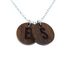 two wooden necklaces with the word ess on them