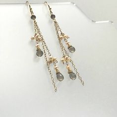 "Our super-glam version of the Waterfall Earring. We have chosen three lengths of chain in either 14K Gold Fill or Sterling Silver and interspersed them with delicate bundles of light blush pink Seed Pearls and a single Rondelle of faceted Smoky Quartz at the top. The chains are then finished with a single Seed Pearl and a faceted tear drop of Smoky Quartz. The effect is nothing less than stunning! Each gemstone is hand wrapped in either 14K Gold-Filled or Sterling Silver Wire before added to th Glamorous Sterling Silver Dangle Chandelier Earrings, Elegant Silver Long Drop Beaded Earrings, Elegant Drop Beaded Earrings For Party, Elegant Nickel-free Chandelier Earrings For Evening, Party Drop Jewelry With Ear Wire, Dangling Beads Drop Earrings, Pearl Drop Dangle Linear Earrings, Nickel-free Dangle Crystal Earrings For Evening, Evening Dangle Linear Earrings For Pierced Ears