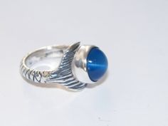 a silver ring with a blue stone on it