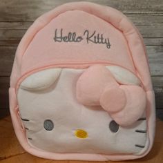 Pastel Pink And Soft Hello Kitty Mini Backpack Zippered Pockets In The Front, Hello Kitty Shaped Pocket With Zipper. Inside- Small Pocket Size: 18cm X 8cm X 23cm Cute Pink Softback Backpack, Playful Hello Kitty Backpack, Playful Hello Kitty Print Backpack, Pink Kawaii Hello Kitty Backpack, Cute Hello Kitty Standard Backpack, Playful Pink Backpack With Cat Design, Cute White Backpack For Playtime, Cute Hello Kitty Print Backpack For School, Cute Hello Kitty Backpack For Back To School