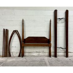 three pieces of furniture sitting on top of a cement floor next to a white brick wall