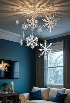 a living room filled with furniture and snowflakes hanging from the ceiling above it