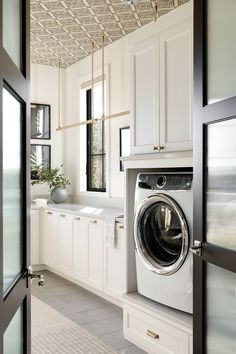 a washer sitting inside of a kitchen next to a window