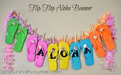 flip flops are hanging on a clothes line with the word aloh spelled out