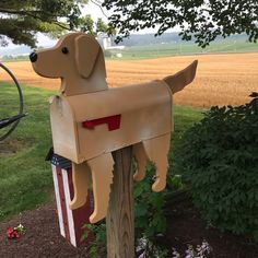 a mailbox shaped like a dog with an american flag on it's chest