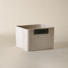 a white box with a black label on it sitting on a table next to a wall