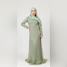 - Round Neckline - Fitted Long Sleeve - Hand-Stitched Pearl And Sage Sequin Embellishment - Fitted Silhouette - Embellished Trail Elegant Green Sequin Dress For Wedding, Elegant Green Sequin Wedding Dress, Elegant Green Embellished Sequin Dress, Elegant Green Formal Sequin Dress, Elegant Green Sequin Evening Dress, Silver Long Sleeve Sequin Dress For Wedding, Dresses To Buy, Sequin Embellishment, Fitted Long Sleeve