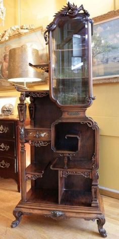 an old fashioned grandfather clock on display in a room with wooden floors and walls,