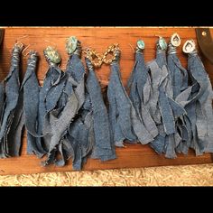 several pieces of blue fabric are laid out on a wooden table with scissors and other items