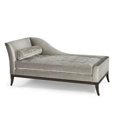 a gray chaise lounge with pillows on it