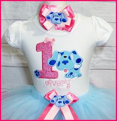 "Super cute Blues Clues personalized birthday tutu outfit. You can purchase the shirt alone or the whole outfit , use the drop down menu to add the items you are wanting to purchase. The shirt is a boutique style white cotton tee shirt with a pink glittery appliqued number with Blue dog and a embroidered name. The full a fluffy ribbon trim tutu was made with a light blue tulle and finished with a hot pink ribbon and has a removable bow you can also included the matching bow to complete the outfi Fitted Blue Top For Birthday, Blue Fitted Top For Birthday, Fun Blue Top For First Birthday, Blues Clues Birthday, Hot Pink Ribbon, 2nd Birthday Party For Girl, Ribbon Trim Tutu, Birthday Tutu Outfit, Tutu Outfits