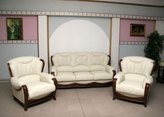 a living room filled with white leather furniture