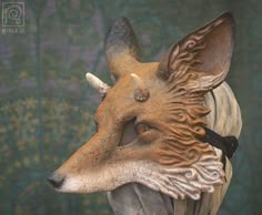 a statue of a fox wearing a collar