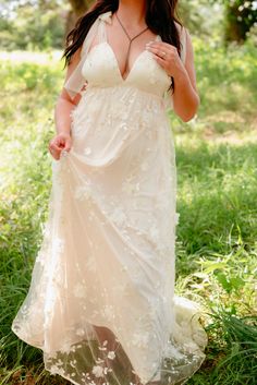 a woman in a white dress posing for the camera