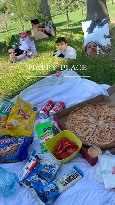 a pizza sitting on top of a white blanket next to a box of chips and snacks