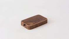 a small wooden box sitting on top of a white surface