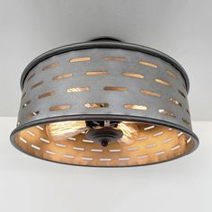 the light fixture is made out of metal and has holes on it's sides