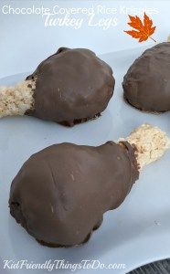 four pieces of chocolate covered in white frosting on top of a paper towel next to an orange maple leaf