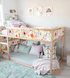 a child's room with a bunk bed and flowers on the wall