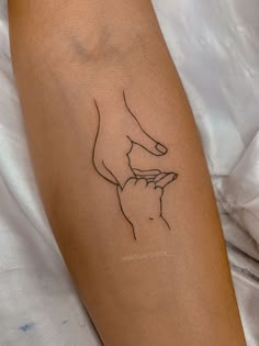 a woman's arm with a small tattoo on it