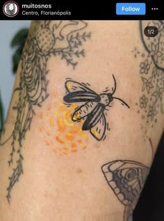 a close up of a person's arm with tattoos on it and a butterfly