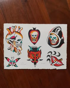 a piece of paper that has various tattoos on it, including one skull and two skulls