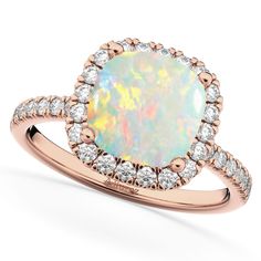 a white opal and diamond ring with rose gold setting on the band, set in 18k yellow gold