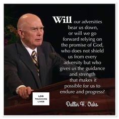 a man in a suit and tie standing at a podium with a bible quote above him