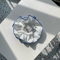 a white and blue flower sitting on top of a table