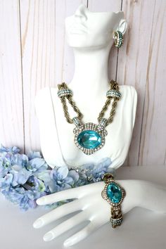 HEIDI DAUS "CHAIN OF EVENTS" BLUE NECKLACE-BRACELET & EARRINGS 3PC SET * BRAND - HEIDI DAUS * NECKLACE - APPROX - 18-1/4"L x 7/8"W WITH 3-3/4" EXTENDER - DROP APPROX - 2-1/4L" x 3"W * BRACELET - APPROX - 7-1/2"L x 1-1/2"W WITH 1/2" EXTENDER - FITS 6-1/2" TO 8" WRIST * EARRINGS MEASUREMENTS - APPROX - 1-1/8"L x 1/2"W * METAL COLOR - BRONZETONE * ROPE CHAIN DESIGNS * COLOR - BLUE * HOOK CLOSURE * OMEGA BACKS * CONDITION - NWT & BOXED * IMPORTED Jeweled Crystal Dangle Jewelry, Crystal Dangle Jewelry With Jewels, Crystal Jeweled Dangle Jewelry, Formal Costume Jewelry With Adjustable Chain, Costume Crystal Jewelry With Jeweled Details, Jeweled Crystal Costume Jewelry, Formal Costume Jewelry With Chain Detail, Formal Costume Jewelry With Chain, Blue Crystal Jewelry With Matching Earrings