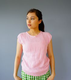 "DESCRIPTION * vintage knitted blouse from 1980s * label Amana for Woolen Mill, made in USA * cropped top style with ribbed waist * pastel pink color * features triangle knit pattern * boat neckline * cap sleeves * tag reads \"Amana/ Made with Pride for Woolen Mills Showroom/ Amana Iowa 52203/ Made in USA\" CONDITION * it is in good vintage condition. Sold as is. ✂------ M E A S U R E M E N T S ------- ✂ Fits like M The shirt is measured by laying flat on a hard surface, it can be stretched out Spring Retro Knitted Tops, Retro Textured Knit Spring Tops, Retro Textured Knit Crew Neck Top, Retro Knit Short Sleeve Tops, Retro Short Sleeve Knit Tops, Retro Fitted Textured Knit Tops, Pink Cotton Short-sleeved Sweater, Pink Short Sleeve Cotton Sweater, Retro Crew Neck Knit Top