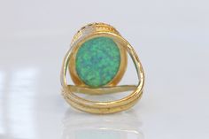 GREEN OPAL RING, Opal Gold Ring, Gemstone ring, October Birthstone, Opal Emerald lawn Gold Filled Ring, Fire Opal jewelry, Opal Big Ring Statement green opal ring made of 14k gold filled the stone is 13*18 mm , it is a perfect to give as a gift for woman Measurements: Size- available all size The center stone is 18mmx13mm Gemstone is a lab opal The ring will be packed in a gift box. FOR MY RINGS COLLECTION HERE: https://www.etsy.com/il-en/shop/rebekajewelry?section_id=14282915&ref=shopsectio Fine Jewelry Green Opal Ring, Green Oval Opal Ring For Formal Occasions, Unique Green Emerald Ring With Gemstone Accents, Unique Green Emerald Ring With Stone Setting, Green Open Ring With Gemstone Accents, Green Multi-stone Open Ring Jewelry, Unique Green Cabochon Opal Ring, Handmade Green Opal Round Ring, Hallmarked Green Opal Ring In Fine Jewelry Style