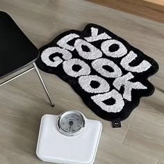 a scale with a black and white rug that says cookbook on it next to a chair