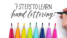 a hand holding a marker and writing the words, 5 steps to learn hand lettering