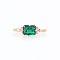 This beautiful east west ring features a 0.97 carat emerald cut emerald with natural earth mined diamonds in solid 14K gold. This ring makes a lovely May birthstone gift for your loved ones! Emerald East West Ring, East West Emerald Ring, East West Ring, Jewelry Appraisal, Solitaire Studs, May Birthstone, Birthstone Gifts, Natural Earth, Custom Jewelry Design