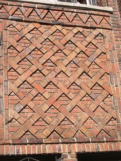 an old brick building with a clock on the side