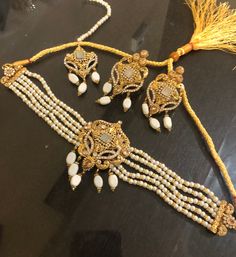 This beautiful set speaks for itself. Get your hands on this Hyderabadi white and champagne stones necklace /choker,earrings,mang tikka set. Set includes : necklace, earrings,tikka, In stock and ready to ship. Hand crafted and gold plated kundan indian/pakistani jewelry Material:brass,stone,gemstone,pearl We bring you casual as well as party wear jewelry which comes with an attractive design and style. It goes well modern and traditional outfits. Visit my website for more collections https://www White Stone Work Tikka As Gift, White Stone Work Tikka For Gifts, Elegant Stone Work Choker For Diwali, Bollywood Style White Jewelry Sets For Eid, White Hand Set Jewelry For Eid, Wedding Choker Jewelry With Stone Work, Elegant White Tikka For Eid, White Kundan Party Jewelry, White Kundan Jewelry For Party