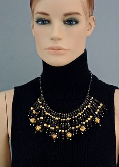 Features: - 100% Authentic CHRISTIAN LACROIX. - Intricate glass beaded collar bib necklace. - Graduated black glass beads and textured metal balls. - Gold tone hardware. - Signed Christian Lacroix CL Made in France. - Lobster closure. - Excellent vintage condition. Measurements: Height: 2.75 inches (7 cm) Wearable Length: 19.29 inches (49 cm) **This necklace will be shipped via Priority Shipping with tracking number. Please convo me for any queries and additional photos. Thank you for visiting. Handmade Black Metal Beaded Necklaces, Artisan Black Beaded Chain Jewelry, Black Artisan Beaded Chain Jewelry, Black Round Beads With Bead Caps, Artisan Black Beaded Chain, Artisan Black Necklace With Beaded Chain, Gold Metal Beaded Necklaces With Black Beads, Gold Metal Beaded Necklace With Black Beads, Gold Metal Necklace With Black Beads