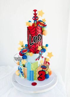 a birthday cake with the number three on it's top and decorations around it