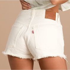 Make Your Summer Style Stand Out With The Levi's 501 White High Rise Cutoff Denim Shorts! Sturdy White Denim (In Levi's Keep It Clean Wash) Shapes These Shorts That Have A High-Waisted Fit With Belt Loops And A Five-Pocket Cut. The Silhouette Is Fitted Through The Hips And Thighs And Ends With Distressed, Raw-Cut Hems. Branded Top Button And Hidden Zipper Fly. Brown Leather Logo Patch And Iconic Red Logo Tag At Back. Unlined. 100% Cotton. White Demin Shorts, White Mid-rise Jean Shorts For Summer, Levi's Cotton Jean Shorts For Summer, White Cutoff Shorts With Frayed Hem, Summer White Cutoff Jean Shorts, White Frayed Hem Jean Shorts For Summer, White Jean Shorts With Frayed Hem For Summer, White Frayed Hem Summer Shorts, White Summer Jean Shorts With Frayed Hem