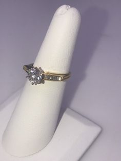 14k yellow gold Diamond Engagement Ring. Center Diamond is .98 ct. I1 clarity, I color, Baguettes total weight .15ct. Size 6 1/4, Circa 2000-2009 Classic Round Cut Diamond Ring Stamped 14k, Gold Cubic Zirconia Wedding Ring With Prong Setting, Classic Round Cut Diamond Ring, 14k Gold Diamond White Diamond Ring, White Diamond Ring In 14k Gold, Gold Baguette Cut Cubic Zirconia Wedding Ring, Gold Baguette Cut Diamond Ring, Wedding Yellow Gold Jewelry With Vs Clarity, Classic 14k Stamped Diamond Anniversary Ring