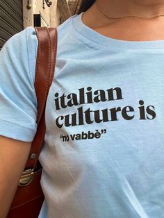 a woman wearing a t - shirt that says italian culture is in vabe '