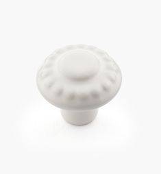 a white ceramic knob on a white background