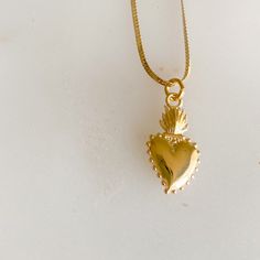 Sacred heart gold charm necklace. Sacred heart charm is 14K gold plate over sterling silver. The symbol represents boundless and passionate love for all of humanity. The flame or light surrounding the heart, signifies the divine light of love. It also symbolizes love for one another. Charm measures about 3/4”. Stamped 925. Hangs on 14K Gold filled (14KTGF) herringbone chain. Measures 18”. BelleStyle logo tag at clasp. Comes in a box inside a linen travel pouch. Made in USA. Waterproof. Spiritual Gold Heart Pendant Necklace, Spiritual Gold Jewelry With Heart Pendant, Gold Spiritual Heart Necklace, Spiritual Gold Heart Jewelry, Gold Heart-shaped Spiritual Necklace, Spiritual Gold Heart Necklace, Symbolic Gold Jewelry With Heart Charm, Spiritual Gold Plated Charm Necklaces For Anniversary, Gold Sterling Silver Open Heart Charm Necklace