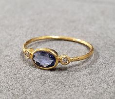 1. 18k Gold Blue Sapphire Ring 2. Made to Order 3. Gemstone - Blue Sapphire 4. Jewelry Type - Gold Ring 5. Total Weight - 1.030 Gram Approx 6. Sapphire Weight - 0.40 Carats 7. Diamond - 0.05 Carats 8. Gold Weight - 0.940 Grams Approx. 9. Sapphire Size - 4x6 MM 10. Gold Purity - 18k 11. Handmade Items 12. Band Size - 1 MM 13. Oval Blue Sapphire 14. AAA Quality 15. Stackable Ring 16. 1 Quantity Available Pictures are taken under natural and day light. Blue And Gold Rings, Oval Blue Sapphire Ring, Golden Sapphire Ring, Vintage Gold Sapphire Ring, Oval Gemstone Ring, Blue And Gold Ring, Creative Rings, Gold Gemstone Rings, Engagement Rings Under 1000