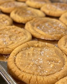 cookies with sugar on them sitting in a baking pan, ready to be baked into the oven