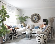 a living room filled with lots of furniture and plants